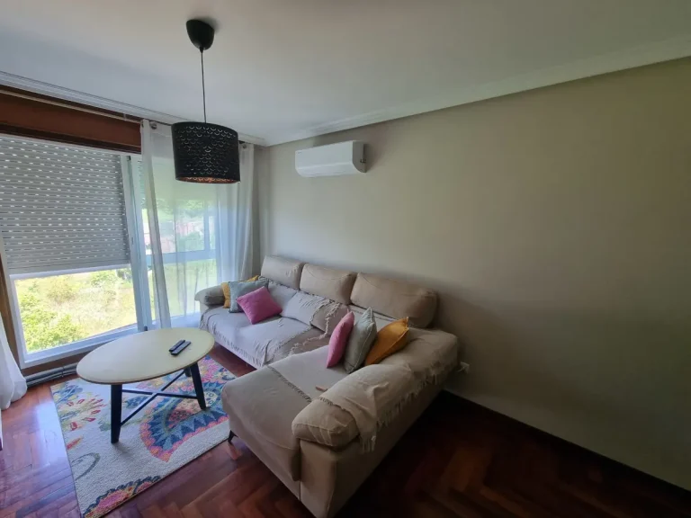 Unidad interior split de aire acondicionado instalada en la pared del salón de un piso en Cangas.